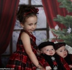 'I wish I had a sister': This little girl can't contain her unhappiness as she poses with her two smaller brothers while wearing matching outfits - although the siblings aren't making a fuss, they too seem downhearted