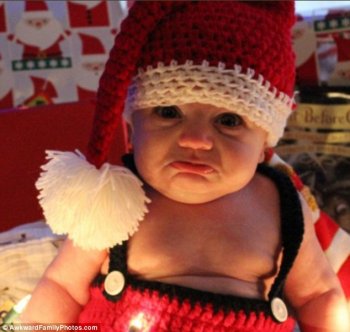 Smile! This baby can't contain his unhappiness at being snapped for a family photo while wearing a crocheted Father Christmas outfit. The parents posted that despite many attempts, that was the best they could get