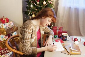 Woman writing christmas cards. - Betsie Van der Meer/ The Image Bank/ Getty Images